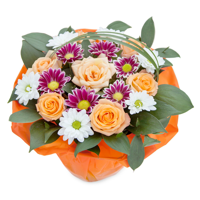 Presented against a white canvas, this striking bouquet showcases the vibrant floristry of Brent Cross, seamlessly blending color, texture, and local inspiration. Central to the ensemble, generously petaled roses in shades from delicate peach to radiant orange offer a gentle, uplifting focal point reminiscent of springtime blooms in local gardens. Interspersed, snow-white chrysanthemums with green-gold centers emulate the classic daisies found dotting pathways near Brent Cross Shopping Centre, while bold magenta-purple accents add visual drama. These are supported by an abundance of dark, glossy foliage-potentially ruscus or similar greenery-that provides a lush, substantial backdrop for the floral stars. A whimsical arc of green bear grass sweeps over the arrangement, hinting at the movement of leaves along local trails. At its base, the bouquet is cradled in bright orange cellophane, its cheerful colour providing cohesion and echoing the vibrancy of North Circular Road. Perfect for gifting, celebrations, or simply sharing a piece of Brent Cross sunshine, this bouquet is a tribute to the area's lively spirit and the skilled hands that bring such creations to life.