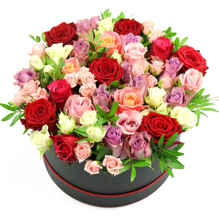 In this image, a black round hat box adorned with a delicate red trim presents a lavish bouquet of roses, photographed against a pure white background that makes every hue distinctly visible. The box's deep, inky surface and slim red border give the arrangement an understated, designer feel, the sort of presentation you might see carried through Brent Cross Shopping Centre on the way to a surprise celebration. Rising from the container is an opulent, dome-shaped mass of roses arranged so densely that the blooms spill over the rim, creating a soft, rounded silhouette. The colour story is lush and nuanced: velvety deep red and crimson roses form the foundation, their petals rich and saturated. Weaving through them are romantic fuchsia and hot pink roses, along with gentler blush and baby pink tones that soften the overall look. Warm coral and peach roses add a hint of golden warmth, while creamy white and ivory blooms introduce highlights that catch the light. Here and there, lavender and muted purple roses peek out, lending a cool, elegant contrast and a touch of modern sophistication. The roses vary in size and stage-some large-headed and fully open, displaying layered, ruffled petals; others smaller, still unfurling, or arranged as dainty spray roses. Slim stems of fresh, glossy greenery, possibly ruscus or eucalyptus, are tucked between the blossoms, giving just enough green to frame the colours without overwhelming them. The overall composition feels meticulously balanced, yet natural, like a carefully curated garden translated into gift form. This hatbox arrangement would make a striking centrepiece for a dinner near Brent Cross or a heartfelt gift for occasions such as anniversaries, birthdays, or a special thank-you, offering a tangible expression of affection and celebration.