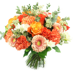 Captured in clear, natural light on a stark white background, this hand-tied bouquet feels like a pocket of sunshine kept deliberately close. The arrangement is tightly rounded and densely populated: prominent orange and golden-yellow roses sit at the heart with their petals forming deep, elegant spirals, while abundant peach and coral carnations provide a soft, ruffled counterpoint that invites the touch. Peach-toned gerbera daisies peek through with flat, fan-like faces and subtle green centres that brighten the composition. Scattered among these larger forms are tiny white accent blooms-perhaps freesia or delicate spray flowers-that give pause and brightness between the richer hues. Airy clusters of pale green, astrantia-like filler add lightness and a botanical intricacy, their delicate stems and tiny heads easing the eye across the bouquet. Signature silvery-green eucalyptus leaves, round and slightly powdery, are threaded throughout, supplying cool tone, sculptural shape, and the faint, cleansing scent that balances the rose's sweetness. The stems are neatly gathered and tied at the base, a clear sign of skilled hand-tying and vase-ready presentation. The overall impression is celebratory yet refined-a bouquet suitable for marking birthdays, anniversaries, or lifting a friend's table on a crisp morning. It carries the tactile contrasts and gentle aromas a florist in Brent Cross would rely on when designing for local customers in Cricklewood, Hendon and nearby residential streets who want bright, fresh flowers with considered craftsmanship.