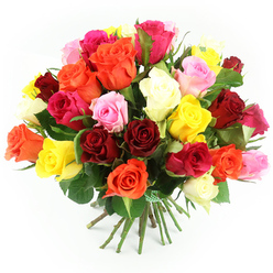 In this image, a striking hand-tied bouquet of roses rests on a clean white surface, glowing with colour as if lit by soft daylight streaming through a window above Brent Cross station. The bouquet is arranged in a generous dome, the blooms massed closely together so that the viewer sees almost no gaps, just a continuous sea of petals. Deep red and wine-coloured roses add a sense of passion and timeless romance, while zesty yellows and warm, fiery oranges weave through them, conjuring feelings of happiness, optimism, and bright celebrations. Gentle pastel pink roses and vivid fuchsia blooms mingle throughout the design, their tones blending smoothly into occasional patches of cream and ivory that add softness and grace. Each bloom displays the characteristic layered spiral of rose petals, some fully unfurled and ruffled at the edges, others still cupped with tighter hearts, suggesting layers of scent and texture. Between the roses, dark green leaves emerge here and there, providing natural framing and contrast, hinting at a bouquet freshly prepared in a local Brent Cross Flowers workshop. The sturdy stems extend downward, neatly aligned and cinched with a green and white checkered ribbon that introduces a charming, almost country-style detail to this otherwise polished arrangement. The white background ensures that all eyes remain on the flowers, while the crisp focus invites the viewer to imagine the soft feel of the petals and the gentle fragrance that such a mix of roses would release. The scene evokes warmth, joy, and thoughtful affection, fitting for birthday surprises, anniversary dinners in nearby Hampstead Garden Suburb, or simply sending love with same-day delivery across Brent Cross and neighbouring areas.