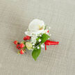 A close-up, top-down photograph of an elegant floral buttonhole resting on a softly textured, light beige woven fabric, similar to linen or fine burlap, like you might see on a rustic wedding table in Brent Cross. At the heart of the design sits a pristine white Phalaenopsis orchid bloom, its broad, velvety petals gently unfurling around a creamy yellow and soft orange throat that glows with quiet warmth. Encircling the orchid, delicate clusters of cloud-like white baby's breath float in all directions, their tiny florets catching the light and adding a dreamy, airy halo around the central flower. Nestled to one side is a compact spray of glossy, round red berries, reminiscent of hypericum, their rich, cherry-red skins polished and festive, hinting at winter celebrations or Christmas weddings around Brent Cross Shopping Centre and nearby North Circular venues. A few paler green buds are tucked in among the berries, suggesting freshness and new beginnings. Slender, smooth green leaves frame the composition, some elongated, others more oval, giving the piece a natural, garden-picked charm. The stems are neatly bound at the base with a vivid red satin ribbon, wrapped tightly and finished with a small knot whose short tails lie gracefully against the neutral background. The soft, even daylight highlights each texture-from the orchid's smooth petals to the woven fabric beneath-creating a refined yet inviting mood. This small corsage or groom's boutonniere feels perfectly suited to a wedding, prom, or formal event in and around Brent Cross, a refined floral accent ready to be pinned close to the heart.