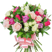 A densely packed, hand-tied bouquet of mixed roses sits against a clean white background, its round silhouette full and inviting. Large, classic roses in soft pastel pink and creamy white form the heart of the composition, some petals unfurled into delicate, velvety spirals while others remain in elegant bud form, offering a pleasing contrast of openness and promise. Bright, deep fuchsia or magenta roses punctuate the arrangement with instant energy, and a few pale lavender blooms lend a cool, gentle note to the colour story. Scattered throughout are clusters of smaller spray roses-mostly creamy white with subtle hints of pale yellow at their centers-adding fine texture and a slightly peppered rhythm between the larger heads. Rich, dark green glossy foliage-likely ruscus or salal-threads between the flowers, the spear-shaped leaves catching light and framing each bloom with fresh, lustrous depth. At the base the long, sturdy stems are gathered and bound, finished with a wide baby-pink satin ribbon tied into a generous, soft bow whose sheen complements the petals. The crisp white backdrop isolates every detail: the satiny petal surfaces, the faint veining, the slight shadowing that gives each flower dimension. Close enough you might imagine a soft, faint rose scent with a green, dewy note-an aroma that suggests celebration without overpowering. This bouquet reads as romantic and cheerful, equally suited for birthdays, anniversaries, Mother's Day or a heartfelt thank-you, and would travel well for local delivery around Brent Cross, Cricklewood and nearby Hendon streets.