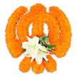A reverent, handcrafted Khanda formed entirely from tightly clustered bright orange marigold heads sits against a crisp white backdrop, the symbol rendered with careful, three-dimensional depth. Thousands of the marigold's soft, velvety petals create the circular chakkar, the two crossed kirpans and the central double-edged khanda in a warm, celebratory blaze of orange; the dense packing of each bloom gives the surface a plush, tactile quality that catches and reflects soft studio light, suggesting both craftsmanship and devotion. Nestled precisely where the swords would cross is a small, sculpted bouquet of pristine white lilies - at least two fully open blooms whose slightly curved petals reveal pale green and yellow stamens - imparting calm and purity at the heart of the emblem. Around the lilies, sprays of tiny white filler flowers and fresh green foliage lift the composition, their glossy leaves and feathery textures providing gentle contrast to the marigold's bushy roundness. A subtle shadow beneath the piece suggests it is freestanding, perhaps placed on a low plinth for a temple offering or a commemorative display. The arrangement smells faintly of citrus-marigold sweetness underscored by the cool, honeyed scent of lilies; visually it balances exuberance with serenity. Crafted in the style of traditional Sikh floral art, this Khanda reads as a tribute - suitable for Vaisakhi processions, Gurpurab decorations, or quiet acts of remembrance - and speaks of cultural pride, spiritual strength and tender respect in equal measure, presented with the quiet dignity of an offering for a sacred space or community celebration in and around Brent Cross and neighbouring Cricklewood.