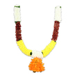 A carefully crafted U-shaped ceremonial garland photographed against a clean white studio backdrop, its form immediately readable even to touch. The garland is built from densely threaded artificial blooms and pom-pom elements that mimic traditional Indian flowers: the short, upright tops of each arm begin with tight clusters of creamy white florets, soft and cloud-like, evoking small chrysanthemums or carnation buds. Below those, a narrow band of deep reddish-brown follows, textured and slightly flattened as if imitating layered dried petals or mahogany-toned material; this grounding hue gives the piece a warm, earthy weight. The curved arms then unfurl into a wide, luminous band of golden-yellow flowers - full, ruffled marigold-like shapes arranged so densely they read as a continuous bright sweep around the lower U. At the very nadir hangs a generous central pendant: a multi-tiered cluster of vivid orange ruffles that forms a round, tactile focal point, the kind of vibrant tassel that anchors an entrance or puja altar. Small pops of green leaf-like accents mark the transition points between colours, offering relief and a hint of freshness. Under soft studio lighting the synthetic petals catch a subtle sheen, suggesting silk or high-quality fabric; the overall texture reads fluffy, layered and durable rather than fragile. As a practising florist in Brent Cross I picture this toran brightening doorways from Cricklewood to Golders Green during Diwali, Ganesh Chaturthi or wedding rituals: a reusable, weather-tolerant alternative to fresh blooms that still carries the ceremonial warmth, scent-memory and visual language of celebration and welcome.
