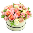 A round cream hatbox cradles a plush, domed bouquet that reads like a quiet sunrise: velvety roses in warm coral-peach and apricot at their centers soften outward to blush pink and creamy ivory, their petals layered in a gentle ombré. Nestled between the larger blooms are clusters of ruffled light-pink carnations, their frilled edges adding depth and a soft, tactile texture that invites the fingertips to linger. The hatbox itself has a refined matte finish and is ringed by two narrow dark bands - one just below the lid and a second at the base - which give the pale container a clean, architectural frame and let the flowers sing against the pure white backdrop. Scattered sparing sprigs of bright green foliage, with small elongated leaves, lift through the bouquet and lend a fresh, dewy note that suggests the scent of an early summer morning. Soft, natural light in the image catches the velour sheen of the petals and the subtle gradations of colour, enhancing the arrangement's handcrafted symmetry and feeling of generosity. The overall effect is elegant and comforting: a tender, thoughtfully composed gift perfect for birthdays, anniversaries, or to brighten someone's day after a long week. As a local florist might explain, this is a design built for presence - a compact, luxurious expression of warmth and appreciation that holds its shape beautifully on a mantelpiece or as a centrepiece for an intimate table.