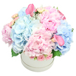 This bouquet is pure poetry in pastels, a harmonious blend of delicate and lush textures that glows in soft, morning light. Billowy blue hydrangeas nestle beside frilled pink peonies, their petals whispering of spring with every nuanced layer. Wisps of pale roses and a scattering of blush calla lilies add sculptural grace, drawing the eye with their serene lines. The arrangement sits lovingly in a round white hatbox, which feels contemporary and clean, letting the blooms speak for themselves. A light, almost nostalgic fragrance rises from the peonies, mingling with the cool freshness of hydrangea as if scent itself were part of the artwork. This bouquet could be a heartfelt gesture of congratulations or comfort-a gentle reminder that beauty and kindness reside in small moments. As a local Brent Cross florist, we place every stem with care, balancing form and fragrance so the piece feels both intimate and enduring. Available for same-day delivery across Brent Cross and the surrounding communities, it brings warmth and grace to birthdays, anniversaries, or new beginnings.