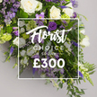 Brent Cross Flowers presents a luxurious Florist CHOICE SPRAY, priced at ?300, captured in a softly lit studio against a pale grey backdrop. The generous spray opens with ivory-white roses in full bloom, their velvety petals catching the light as if woven from silk. They are paired with white lisianthus whose bells and ruffled edges add graceful texture, and slender white freesias whose delicate fragrance lingers in the air. A chorus of purples provides depth: deep purple lisianthus, lavender-tinted eustoma, and soft lilac freesias mingle with tall spikes of purple veronica or delphinium that rise to create vertical drama. Clusters of lavender limonium drift like whispering lace, while fern fronds and broad, glossy leaves carve a verdant, cascading frame. Light-green viburnum clusters punctuate the arrangement with a fresh brightness that cleanly offsets the richer purples. A crisp white rectangular overlay sits at the center, bearing Florist CHOICE SPRAY in flowing script for the word Florist and bold uppercase CHOICE SPRAY, with the price rendered in large white numerals beneath. The image communicates premium floristry, suggesting it suits solemn sympathy tributes, funeral sprays, or a grand gift for a significant milestone. This design reflects Brent Cross's floral craft, and is available for delivery across the NW4 postcodes including Brent Cross, Cricklewood, and Golders Green, echoing the local knowledge of seasonal blooms. The overall mood is opulent yet natural, a balanced blend of open blooms and textural greenery that speaks to timeless elegance and contemporary design.

It is a piece that invites careful viewing, as if the petals release a quiet memory with every glance. For families and friends in Brent Cross and beyond, the spray promises both visual impact and lasting freshness, crafted by a skilled local florist who understands how colour, texture, and light can convey comfort.